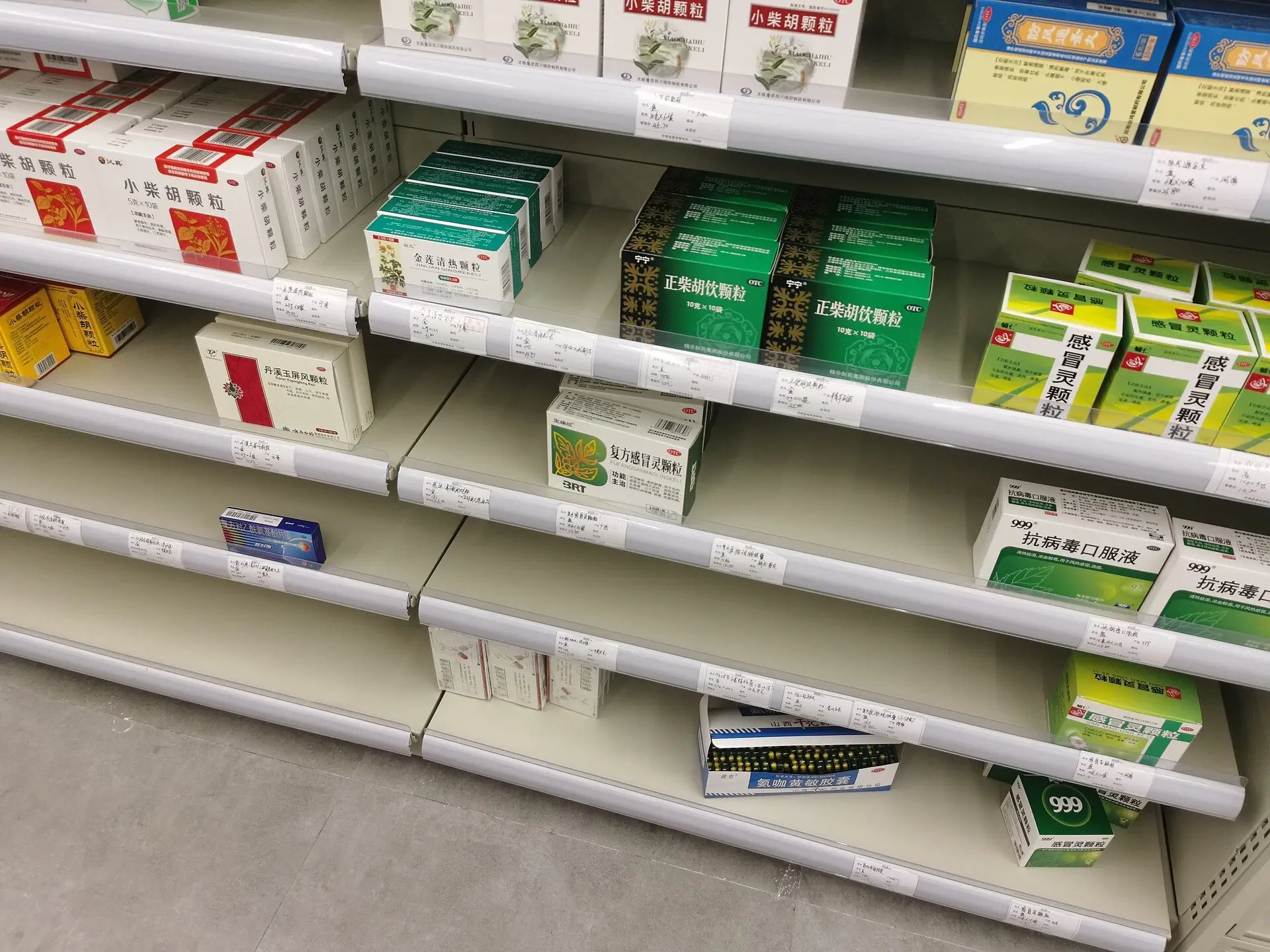 Estantes de una farmacia con varios huecos vacíos